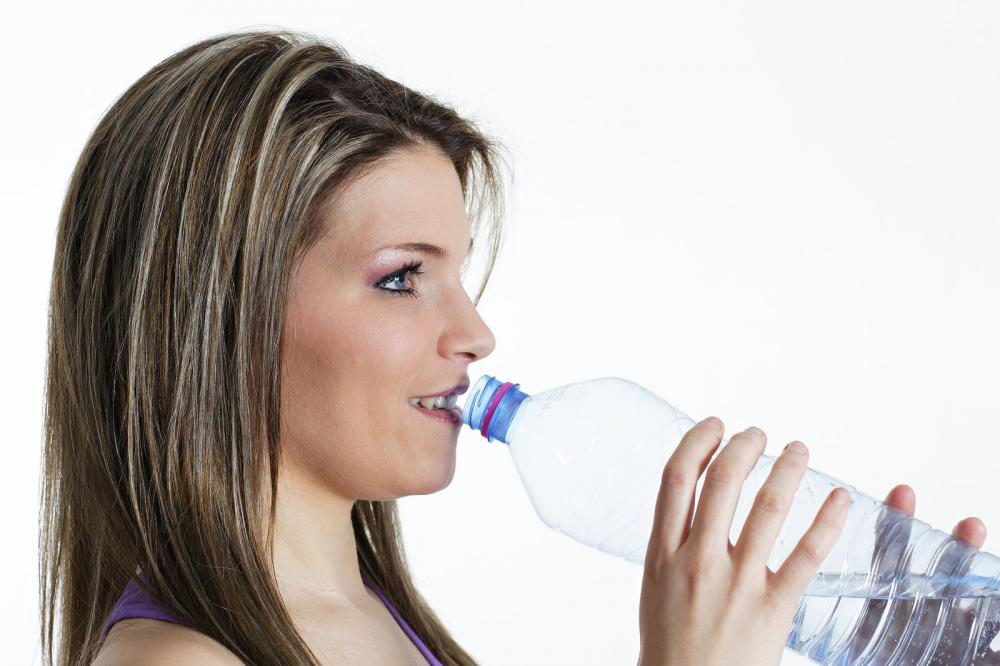 Woman drinking water for youthful skin