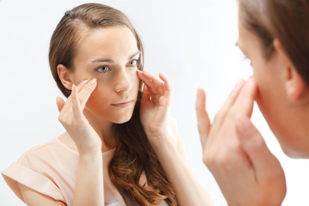 Women looking at her first wrinkles.